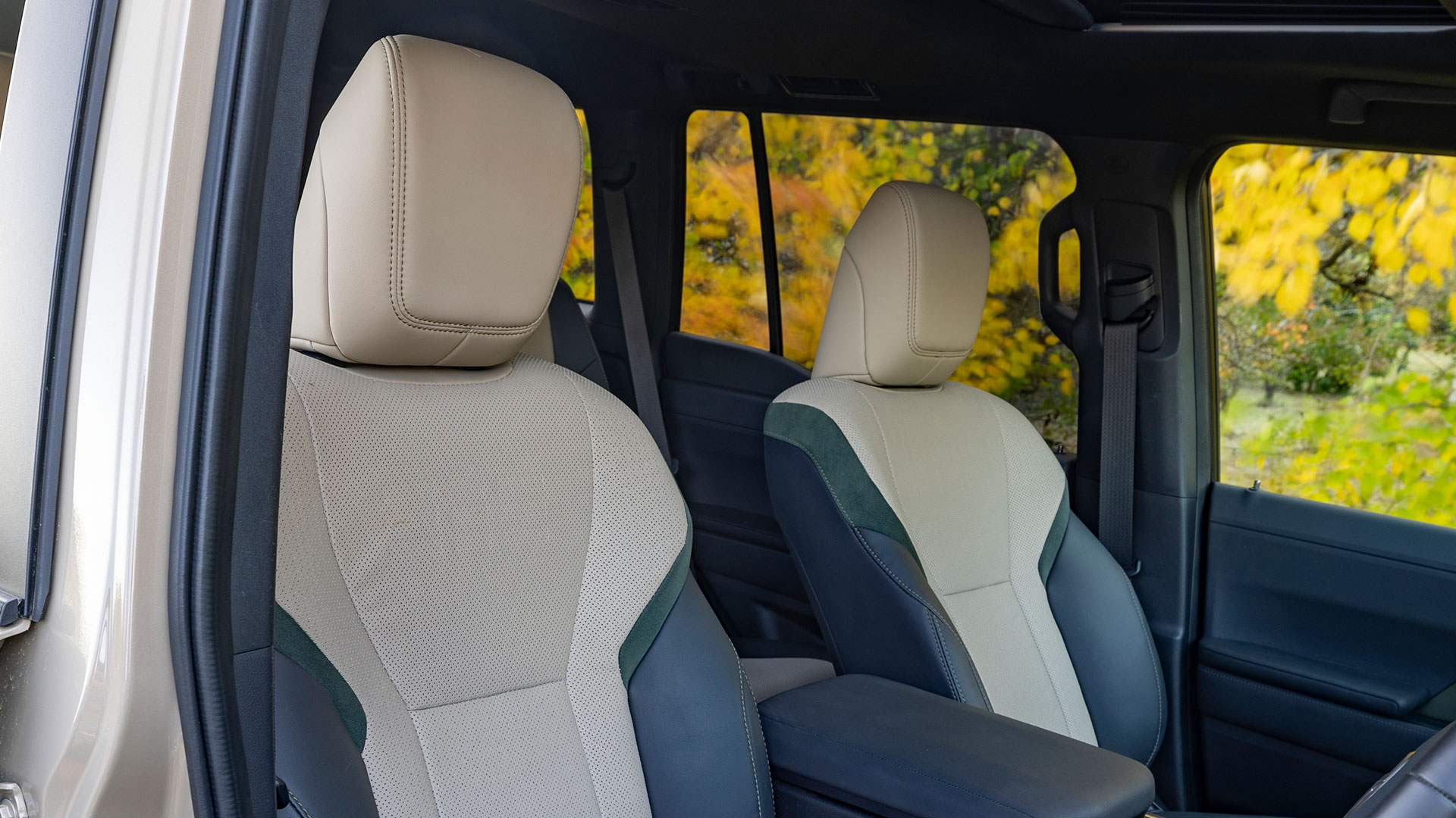 The interior front cabin of the Lexus GX featuring luxury two tone leather seats. 