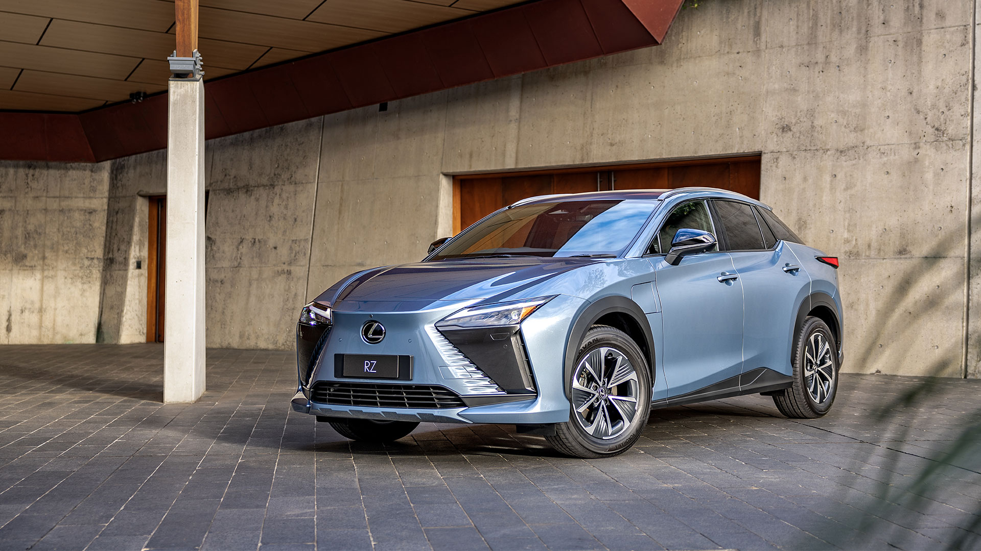 A blue Lexus RZ vehicle parked in a driveway